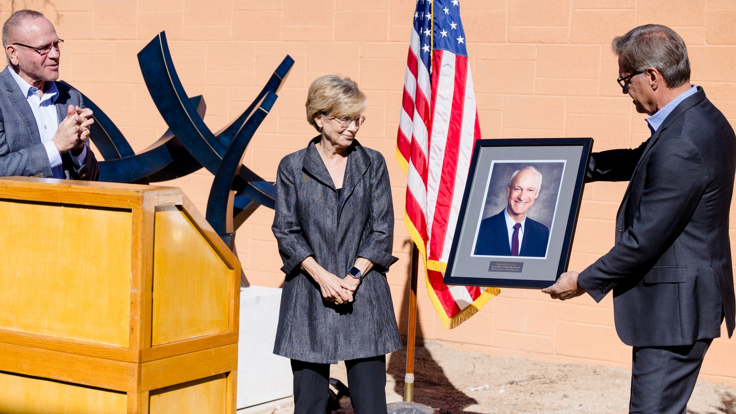 Guests at the Edmund H. Portnoy memorial dedication viewing his commemorative portrait